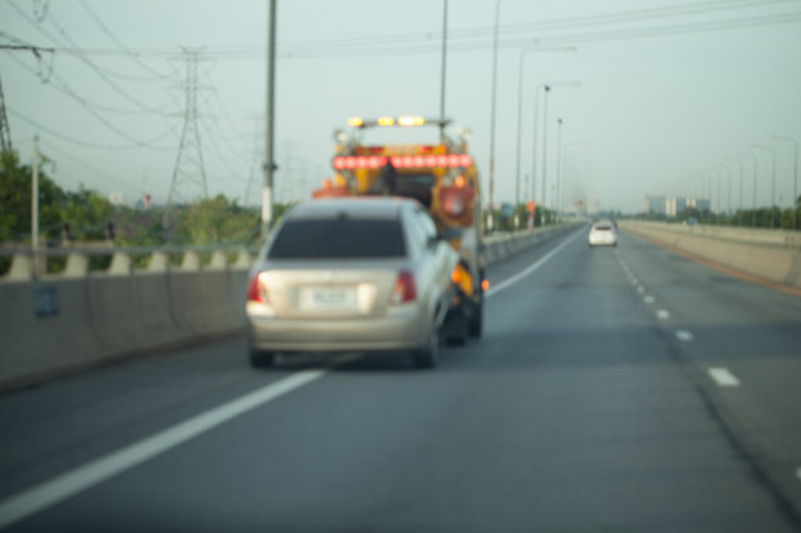 towing a sedan on the freeway