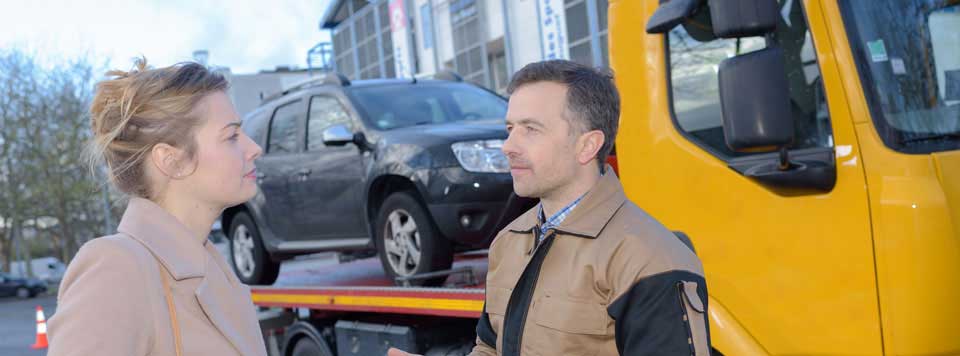 A good tow truck driver reassuring an anxious person