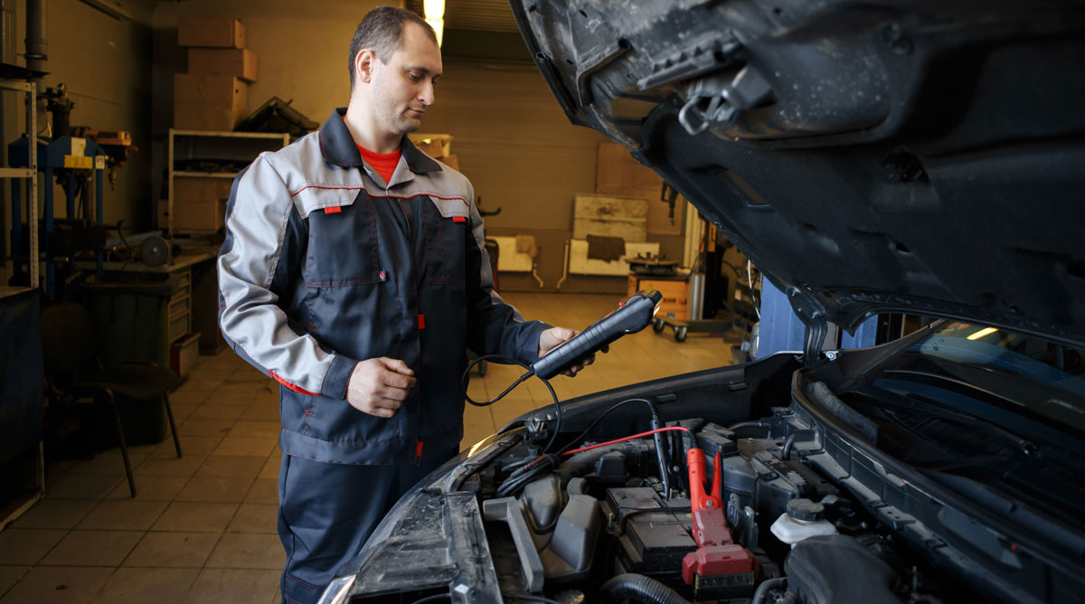 An image of a guy testing a starter motor.