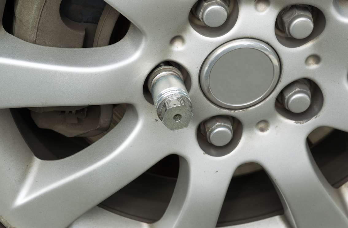 Lock in wheel nut on a bolt in a wheel ready to be turned.