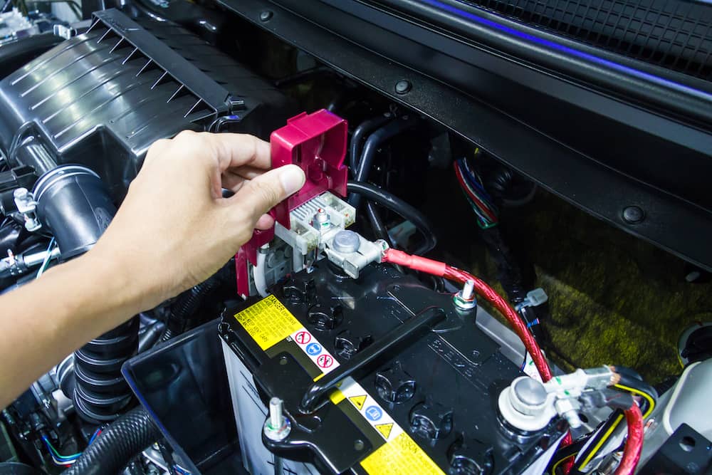 A brand new car battery safely installed.