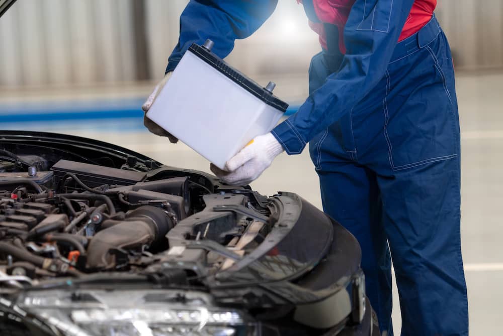 Removing a battery from a car.