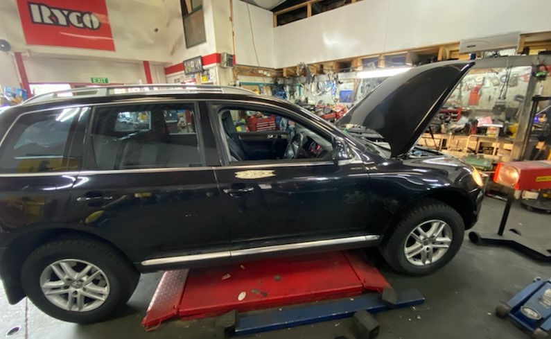 An SUV being repaired at a shop.