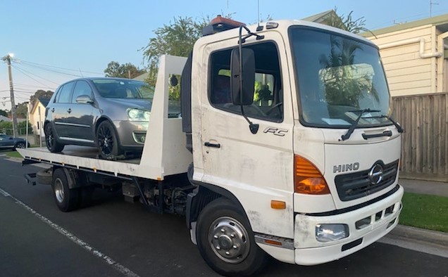 A towed hatchback car.