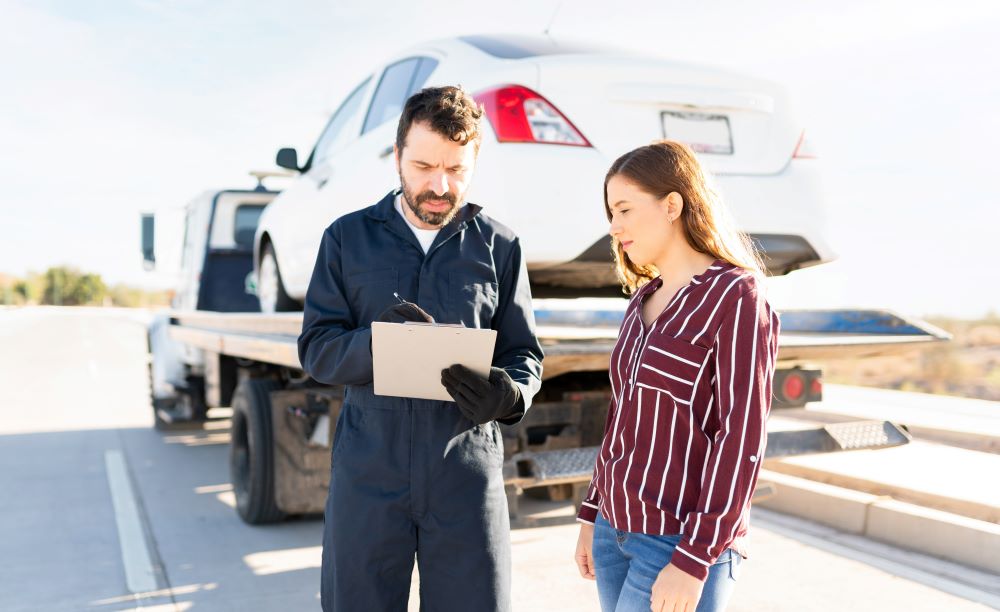 Tow truck driver showing invoice to customer.