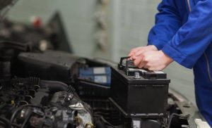 Mechanic changing car battery.