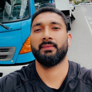 Amritbal Singh is standing out in front of a tow truck in Melbourne CBD.